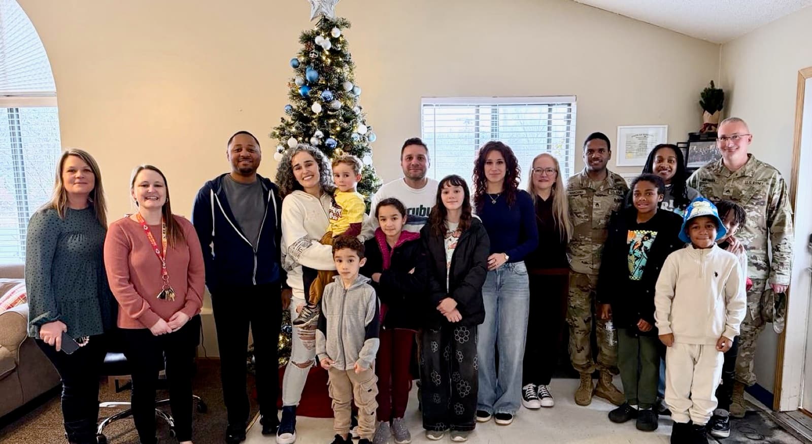 A large House of Compassion gathering — residents, staff, and community during the holidays.